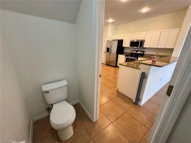 Bathroom featuring light tile patterned floors and toilet