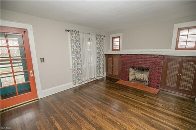 The living room is highlighted by a decorative fireplace and built in cabinetry.