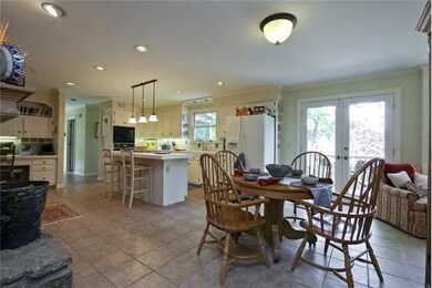 Large, tile eat-in kitchen with stone fireplace.  Cook and visit by the fire.