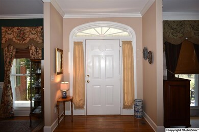 Formal Entry Foyer with Crown Molding, 9 ft Smooth Ceilings and Hardwood Flooring