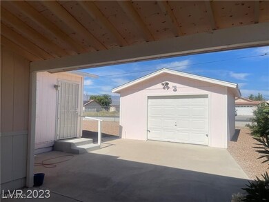 Detached garage with fence and concrete driveway
