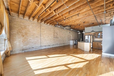 Unfurnished living room with light wood-type floo
