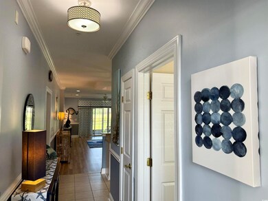Hall featuring crown molding and wood-type floorin
