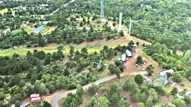 Aerial view of property and surrounding area featuring rural landscape