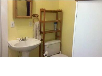 beautiful bathroom with shelving and pedestal sink