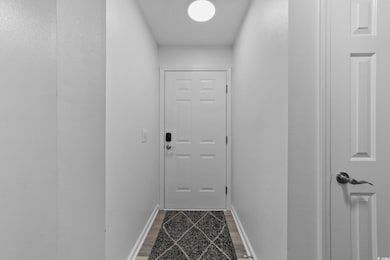 Doorway featuring hardwood / wood-style floors