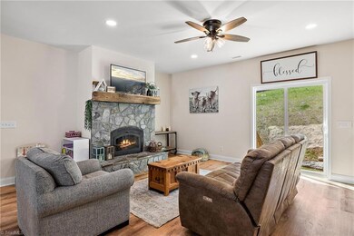 Living room with stone wood-burning fireplace.