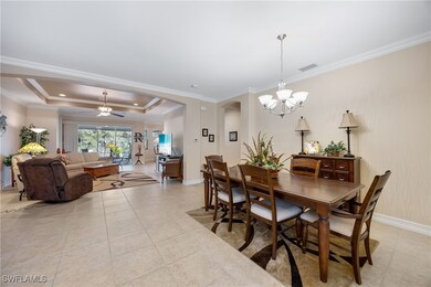 Tiled dining space with ceiling fan with notable c