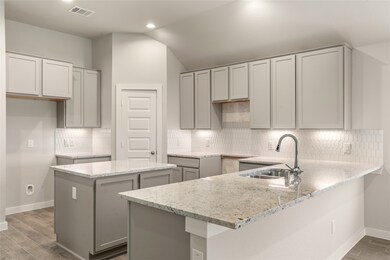 This kitchen is by far any chef’s dream! This spacious kitchen features high ceilings, cool stained wood cabinets, granite countertops, SS appliances, modern tile backsplash, recessed lighting, extended counter space, separate island, space for breakfast bar, and a walk-in pantry all overlooking your huge family room.
