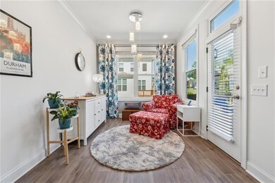 Living area featuring ornamental molding and wood finished floors