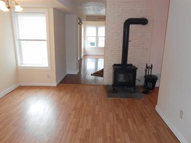 Dining room with wood stove and laminated flooring
