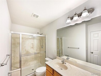 Full bathroom featuring a shower stall and vanity