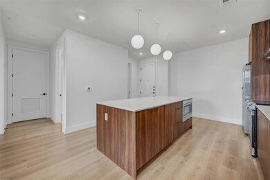 Kitchen with a kitchen island, modern cabinets, a