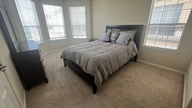 Primary bedroom with queen size bed and four large