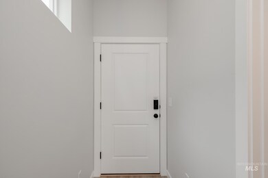Entryway with baseboards and wood finished floors