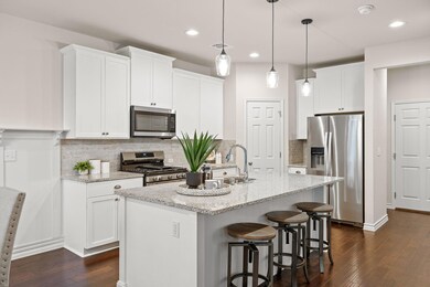 Kitchen with dark wood-style flooring, appliances