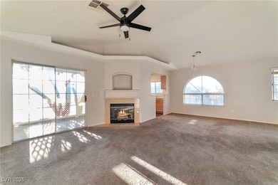 Unfurnished living room with carpet, lofted ceilin