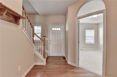 Foyer with stairs and light wood finished floors