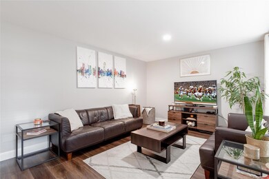 Living area featuring baseboards, recessed lighti
