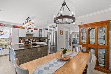 Dining space featuring crown molding, sink, and ce