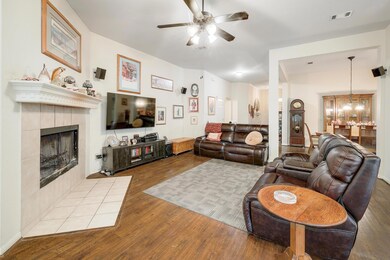 Living room featuring ceiling fan, wood finished 