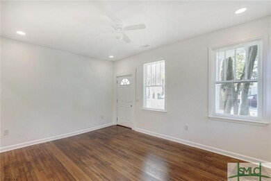 The living room is spacious and open. The original
