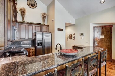 Kitchen with a peninsula, wood finished floors, ap