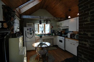 Kitchen with bay window looking to...
