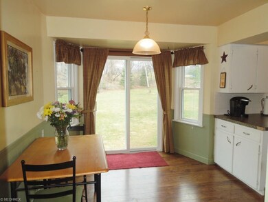 Eat in kitchen area with beautiful wood floors and