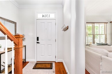 Foyer entrance with wood finished floors, crown mo