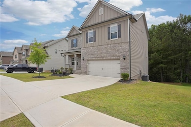 Craftsman-style home with board and batten siding, concrete driveway, a front yard, brick siding, and central air condition unit
