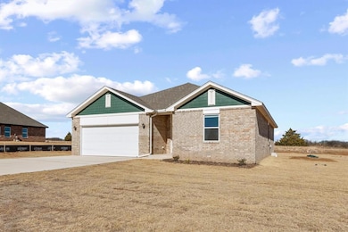 Ranch-style home featuring brick siding, driveway,