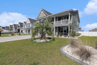 View of front of property with a balcony, a gate, a residential view, and concrete driveway