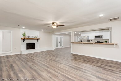 The open concept and new laminate wood flooring make this living area a dream, complete with fireplace and beautiful butcher block bar.