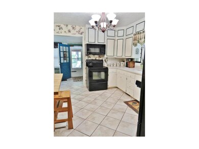 Wonderful Kitchen with Solid Surface Counters, loads of Cabinets and Ceramic Floors