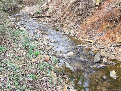 Small rushing stream with culvert at rear portion 
