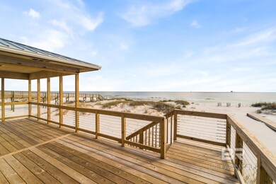 Dock area featuring view of local beach and a deck with water view