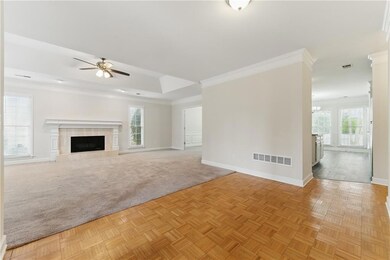 Unfurnished living room with ornamental molding, b
