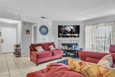 Living area with light tile patterned floors, a te