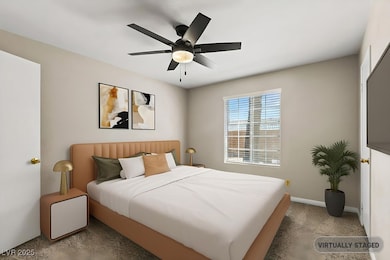 Bedroom with carpet, baseboards, and a ceiling fan