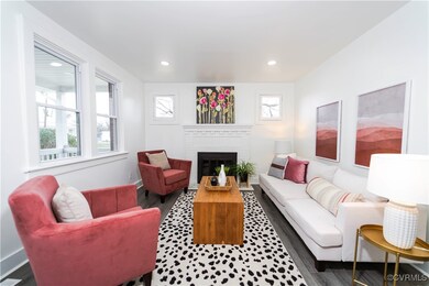 Living room featuring a fireplace and dark hardwoo