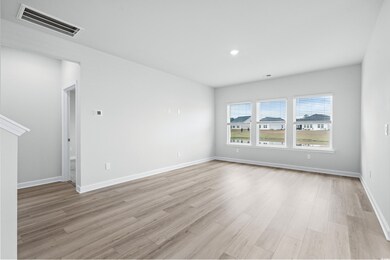 Spare room featuring light hardwood / wood-style f