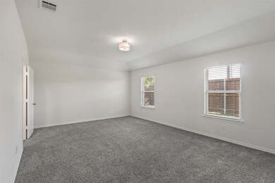 Carpeted empty room featuring baseboards