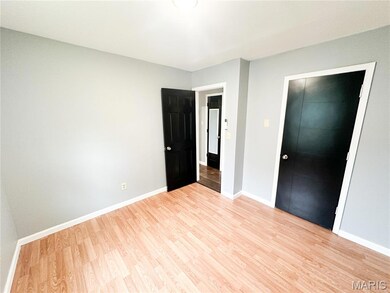 Unfurnished bedroom featuring light wood-type flooring and a closet