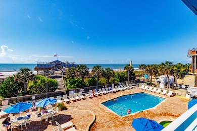 Community pool with a water view and a patio area