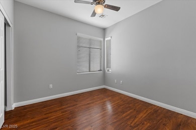 First floor bedroom with baseboards, dark wood fin