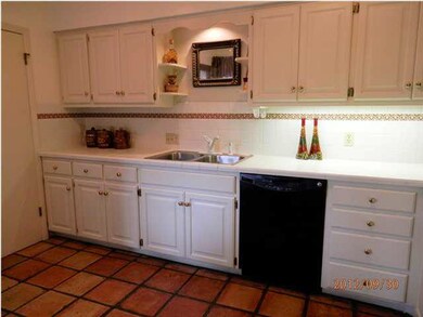 Large kitchen w/ tile floors and pantry.