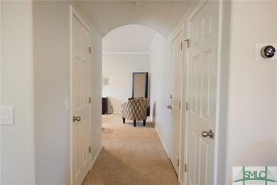 HALLWAY TO FAMILY ROOM: Arched doorways found thro