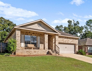 Single story home with driveway, brick siding, a garage, and covered porch