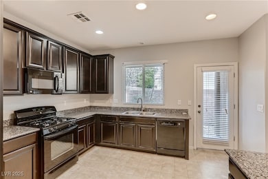 Kitchen featuring black appliances, recessed light